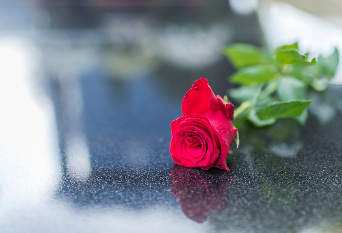 Gravestone with withered rose